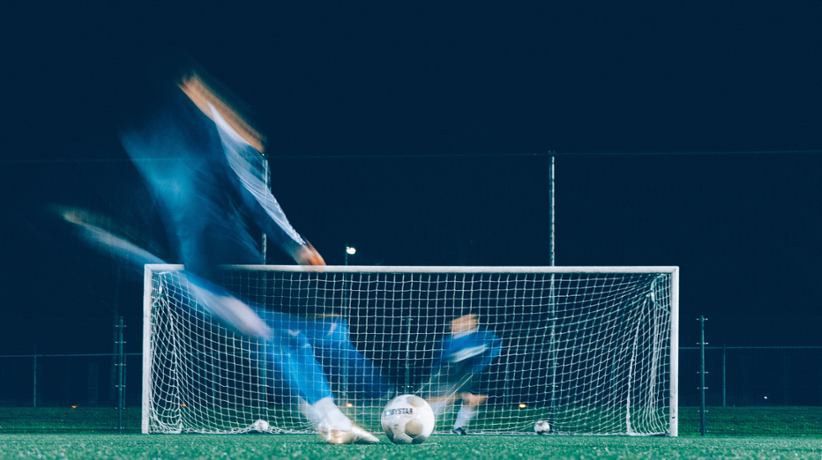 A soccer player shooting a penalty shot.