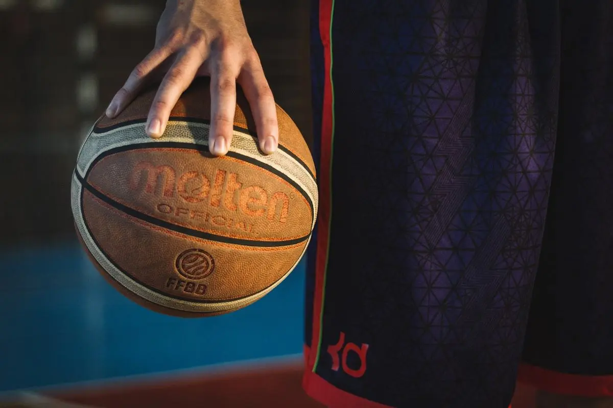 man-holding-basketball-with-one-hand