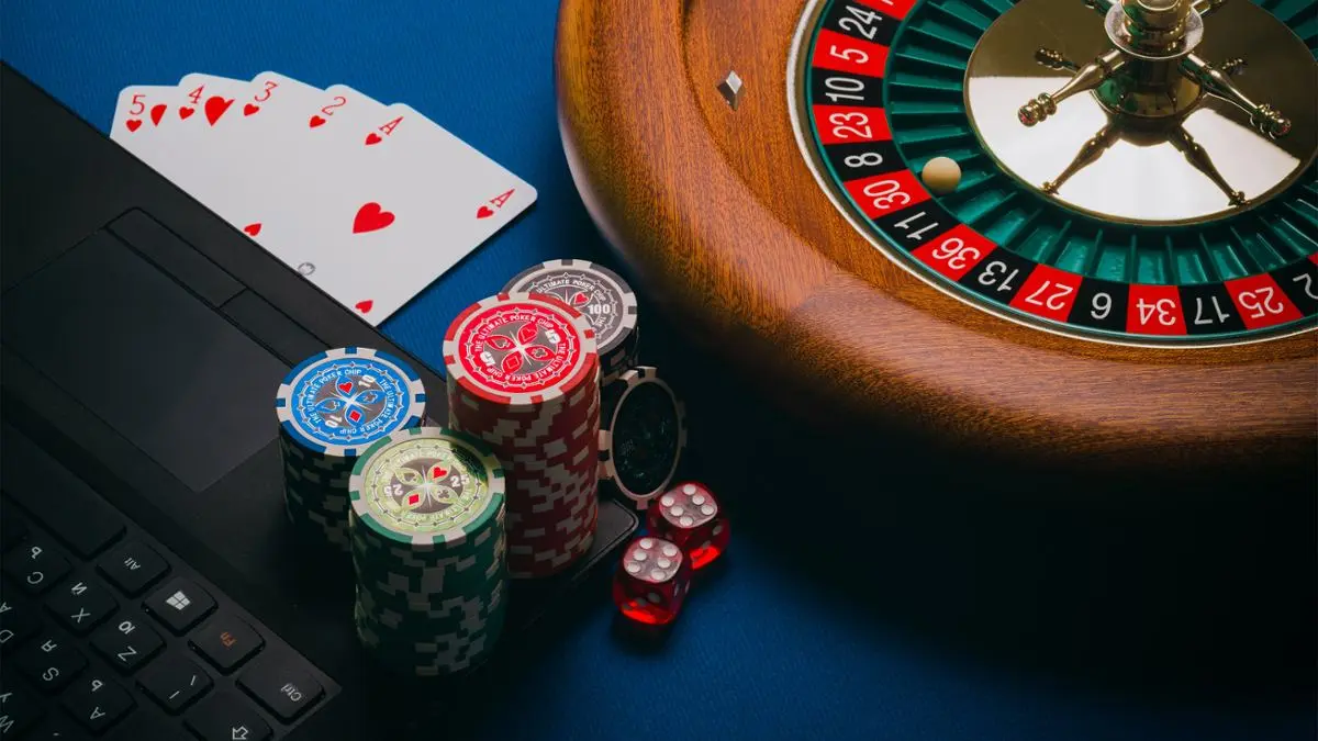 A bunch of gambling paraphernalia and laptop.