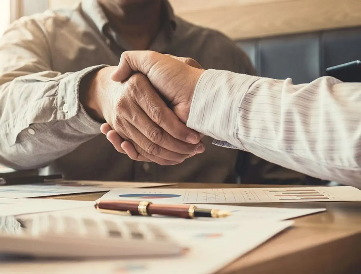 two-businessmen-shake-hands-after-deal