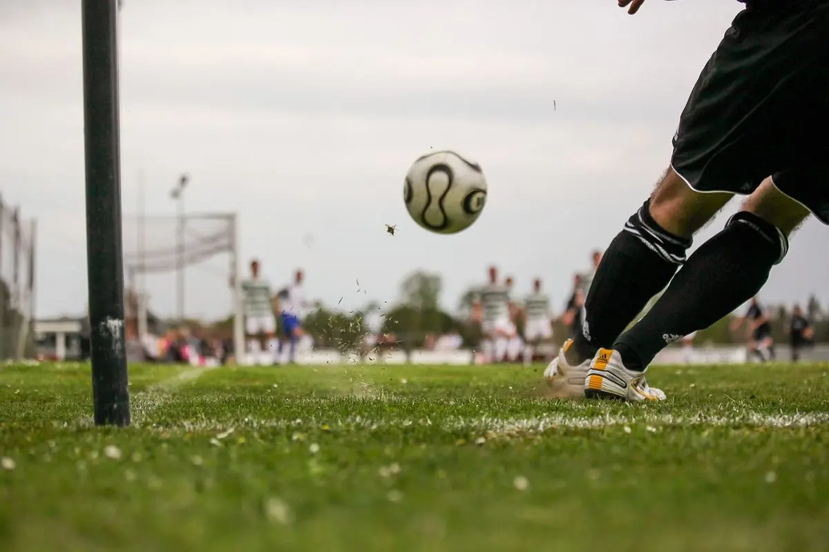 soccer-player-kicking-ball-on-field