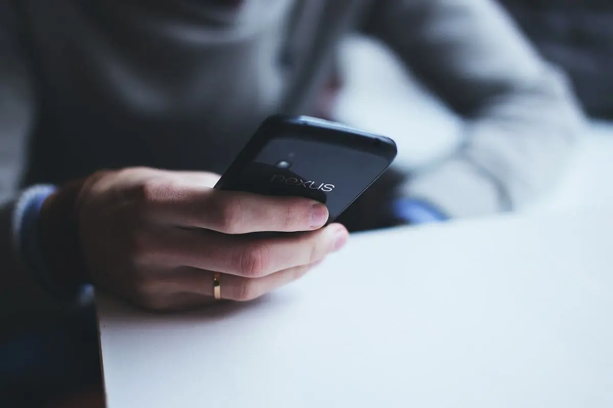 close-up-photo-of-man-holding-smartphone