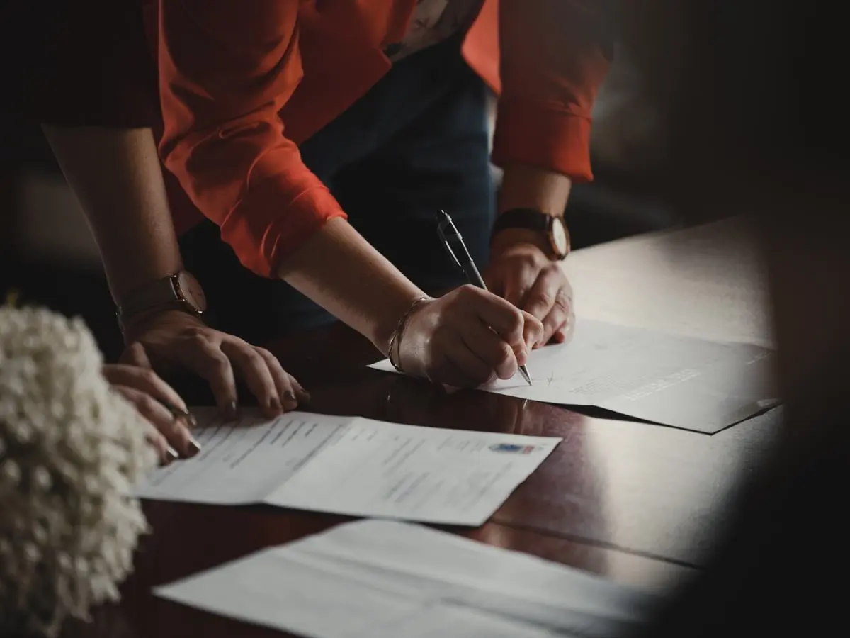 A person signing a legal complaint.