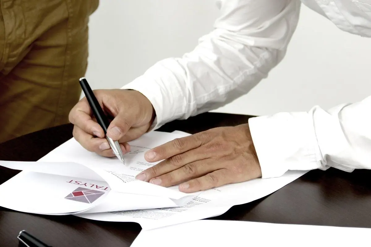 businessman-signing-a-document