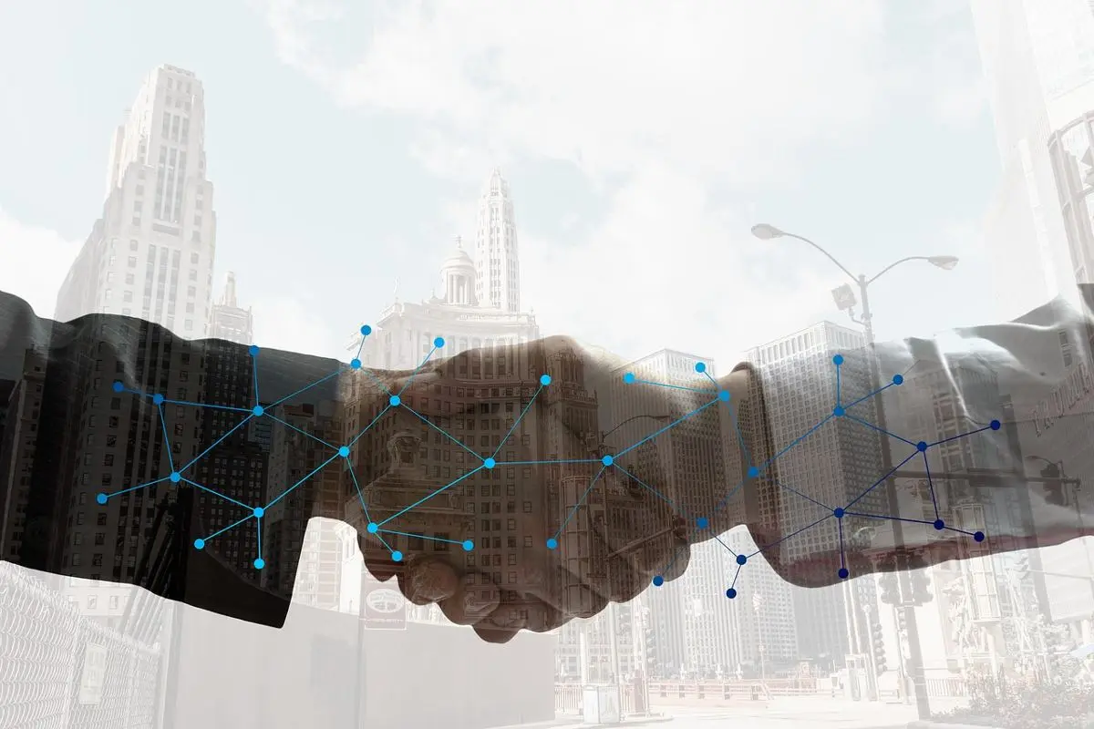 businessmen-shaking-hands-digital-partnership