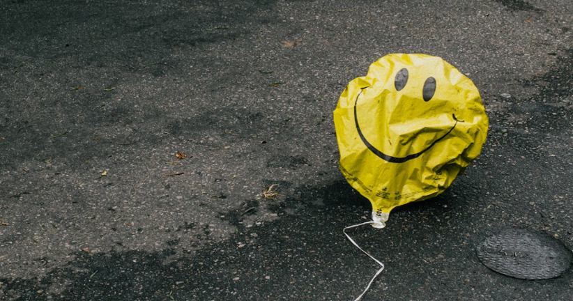A sad balloon on the street.