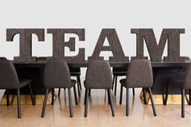desk-and-chairs-conference-room-with-word-team-written-on-wall