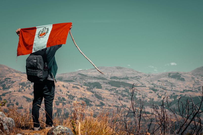 Peru's national flag waved by a tourist.