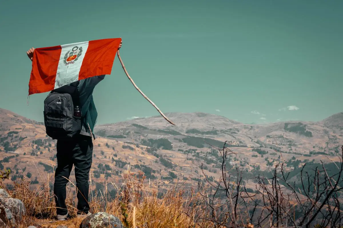 Peru's national flag waved by a tourist.