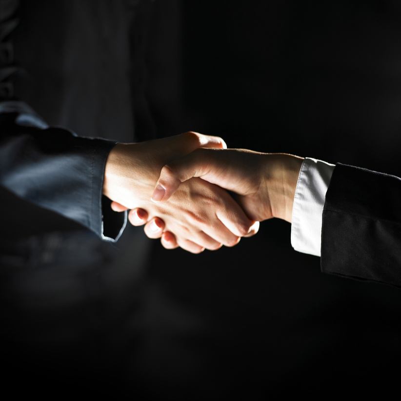 two-businessmen-shaking-hands-deal-partnership