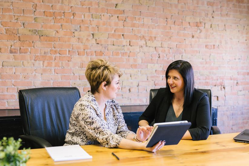 Promotions women discussing something.