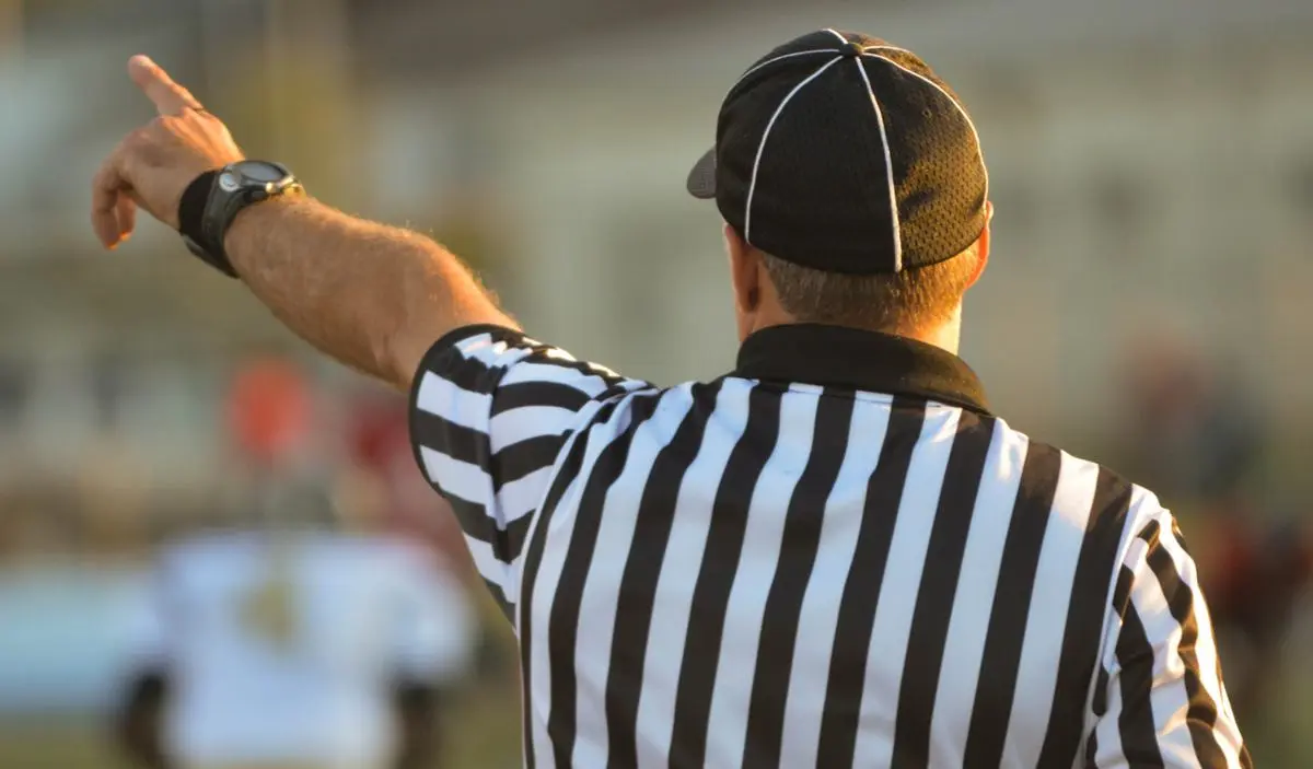 A referee saying something.