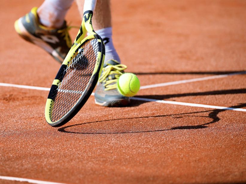 close-up-photo-of-racket-and-tennis-ball-on-court