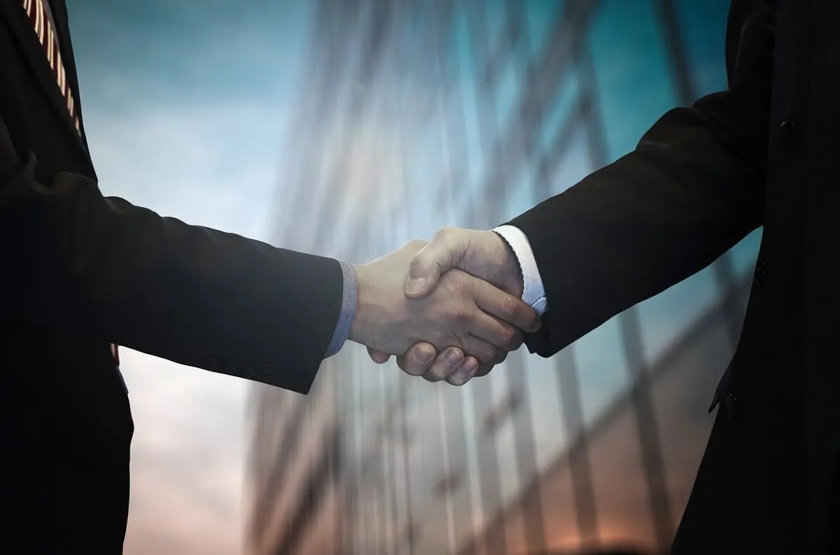 two-businessmen-shake-hands