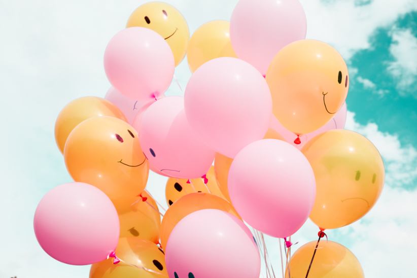 A bunch of balloons smiling.