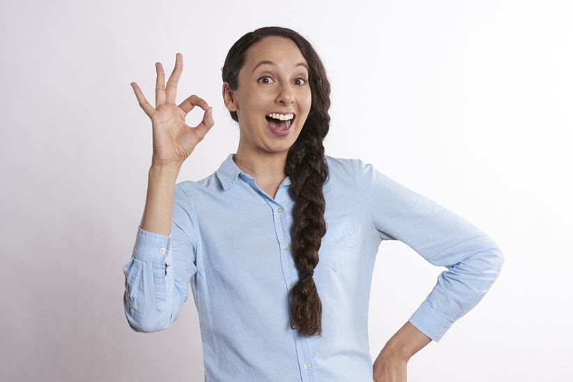 A woman showing the OK sign.