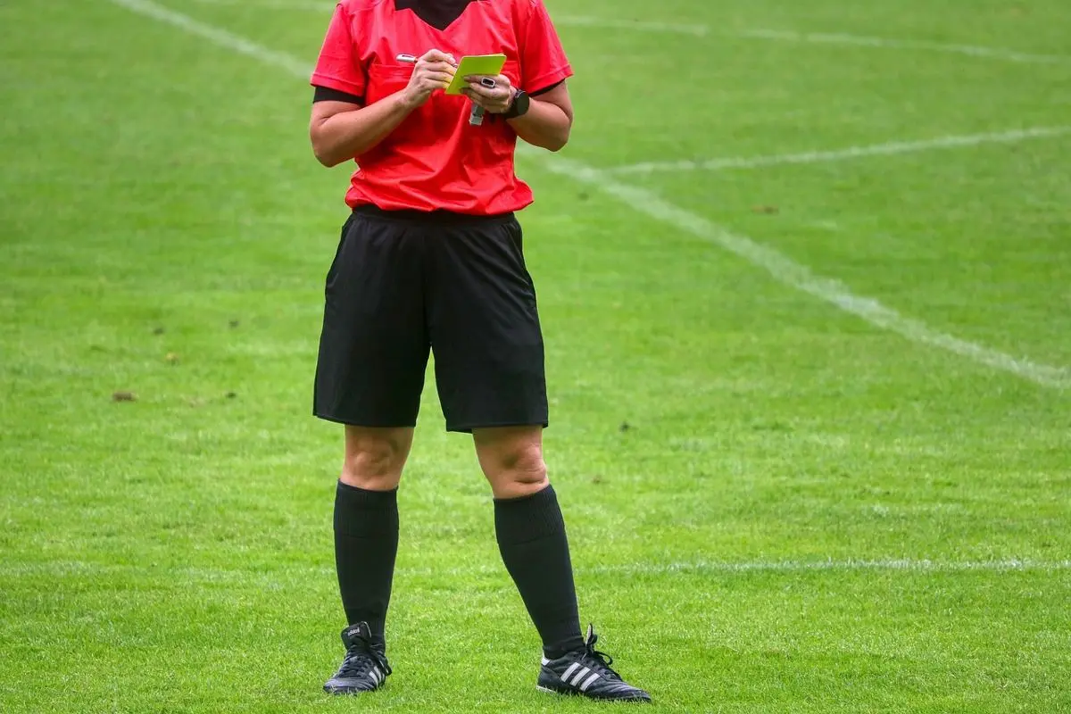 A card been given out to a soccer player.