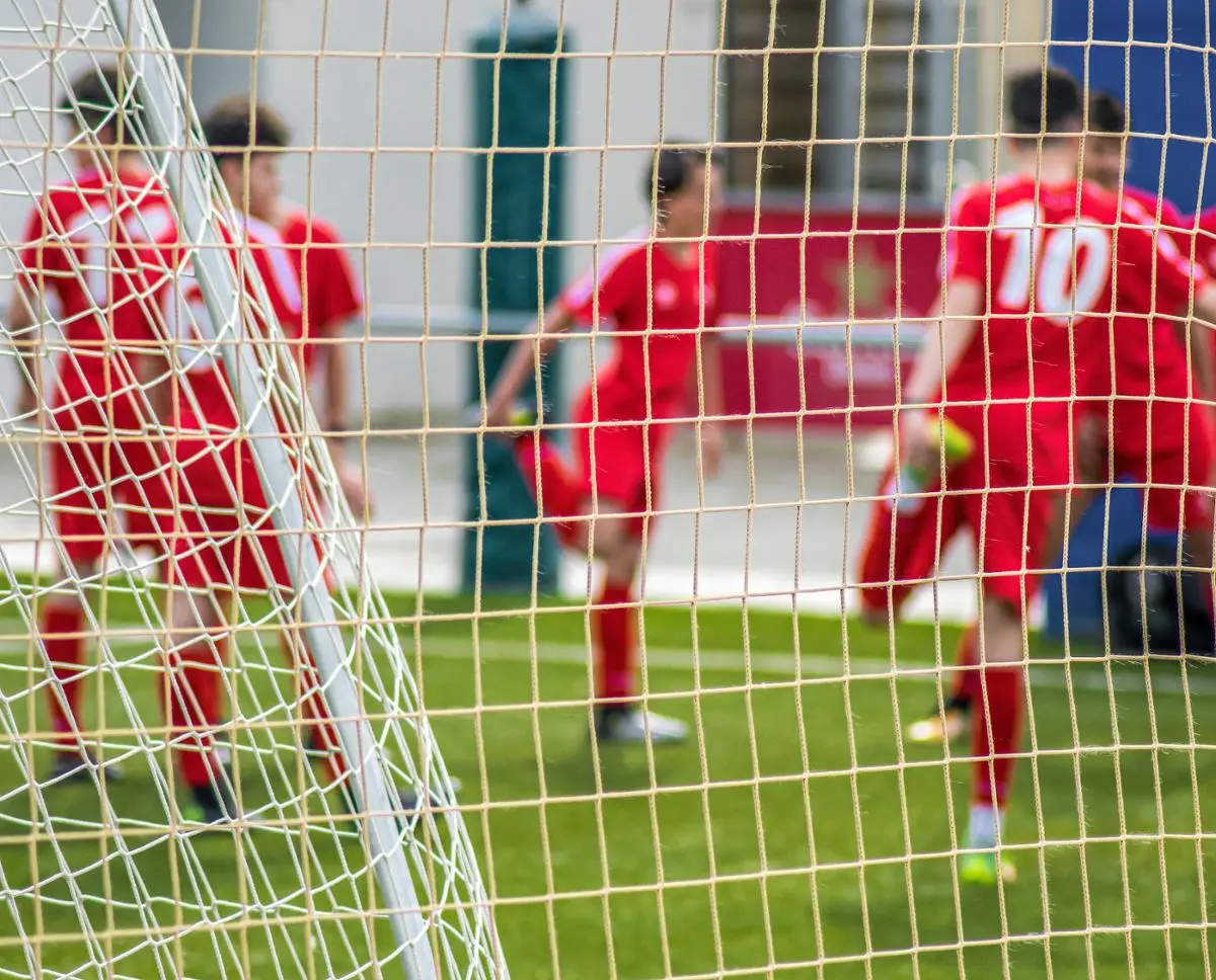 soccer-player-behind-soccer-net