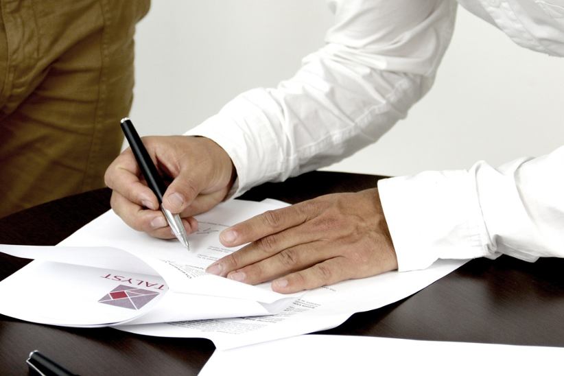 a-businessman-signing-a-document