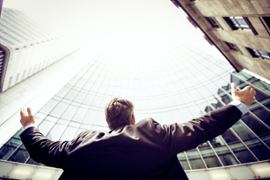 A man cheering at the sky.