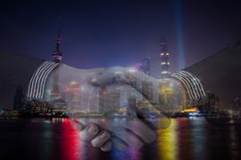 two-businessmen-shake-hands-on-a-cityscape-background