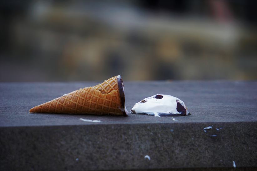 An icecream cone dropped on the ground.