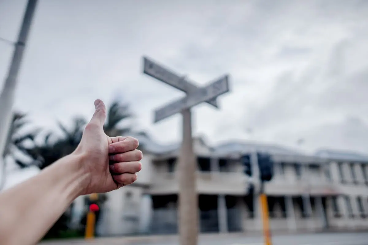 Thumbs up at a crossroad.