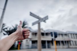 Thumbs up at a crossroad.