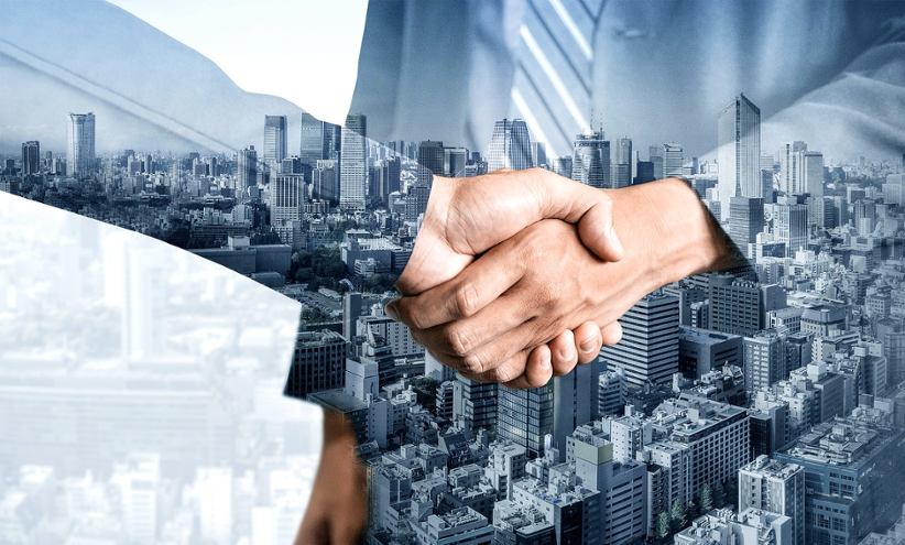 two-businessmen-shake-hands-cityscape-background