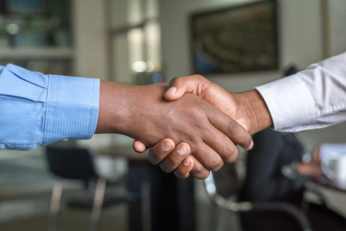 Partnership two people shaking hands.