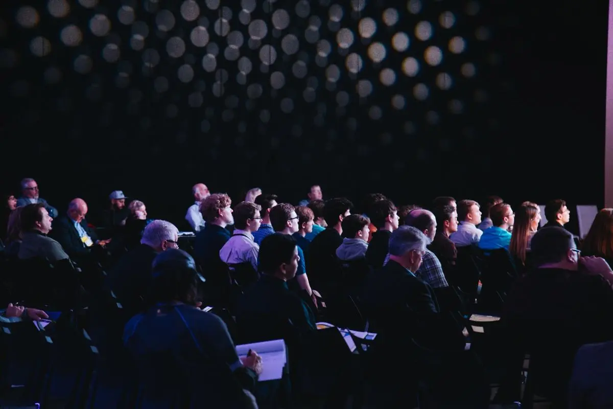 A panel with a lot of people attending and listening to the speaker.