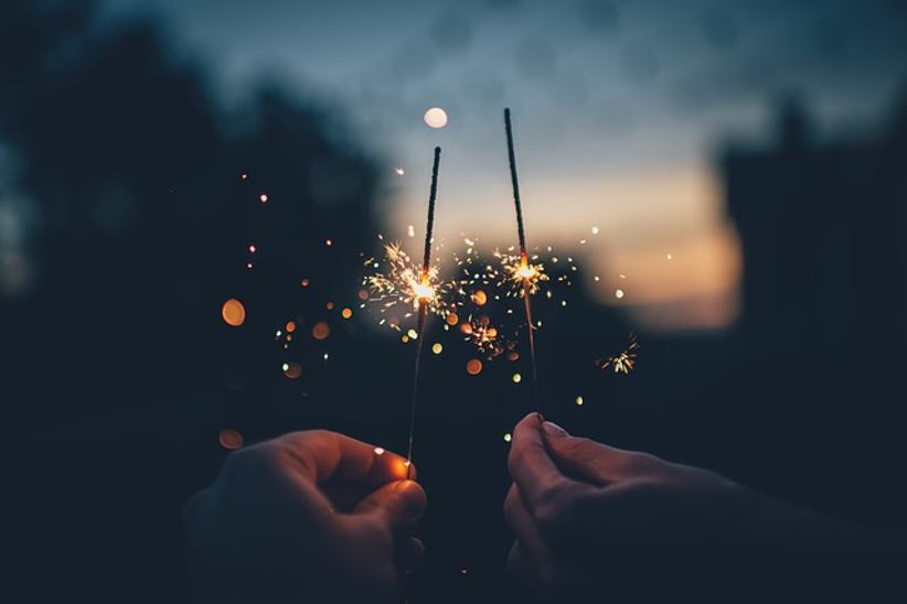 two-hands-holding-sparklers