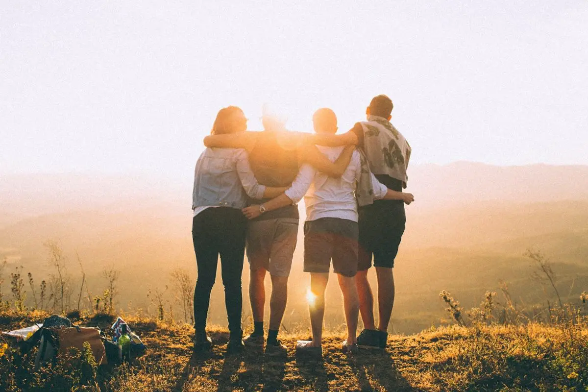 People hugging and looking at the sunshine.