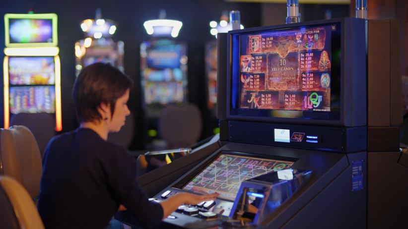 A person playing at a slot machine.