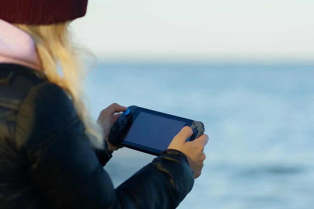 A girl holding a game console.