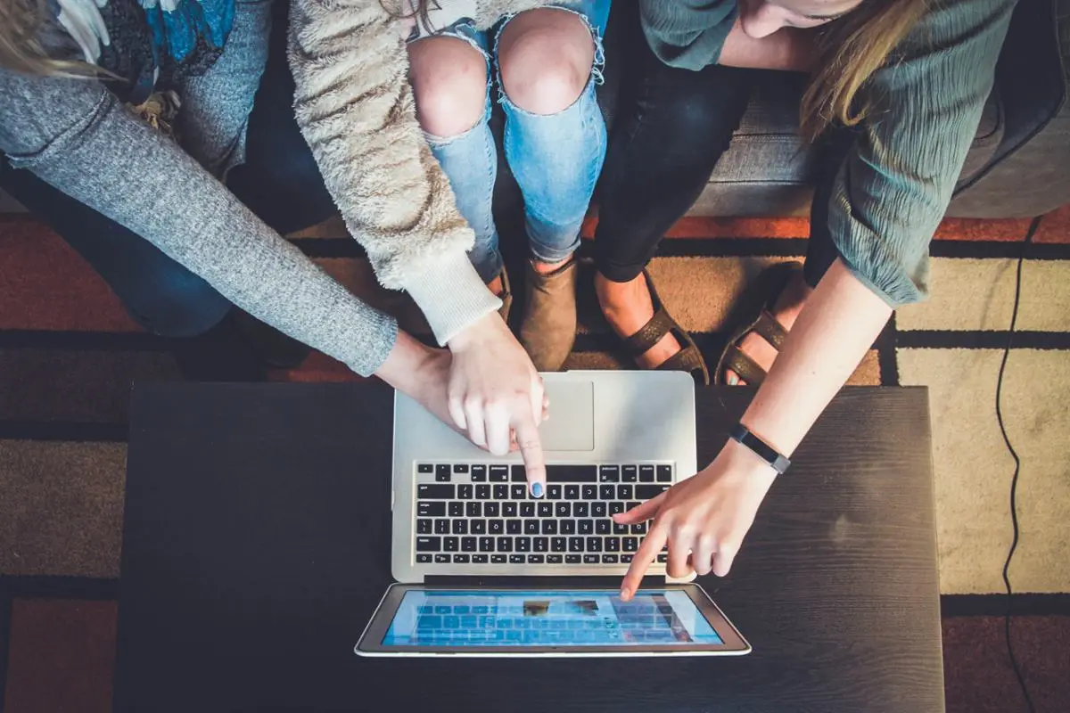 three-persons-in-front-of-a-laptop