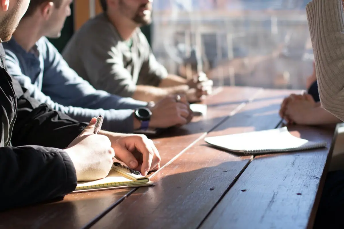 A group of people discussing business.