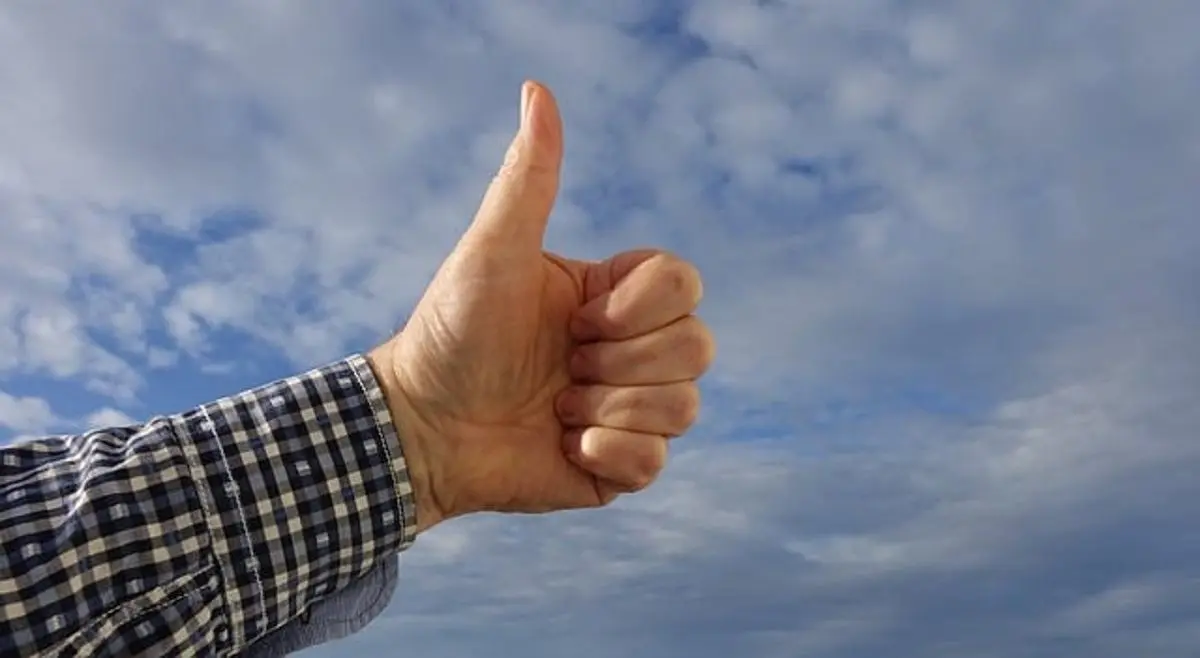 thumb-up-hand-clouds-in-background