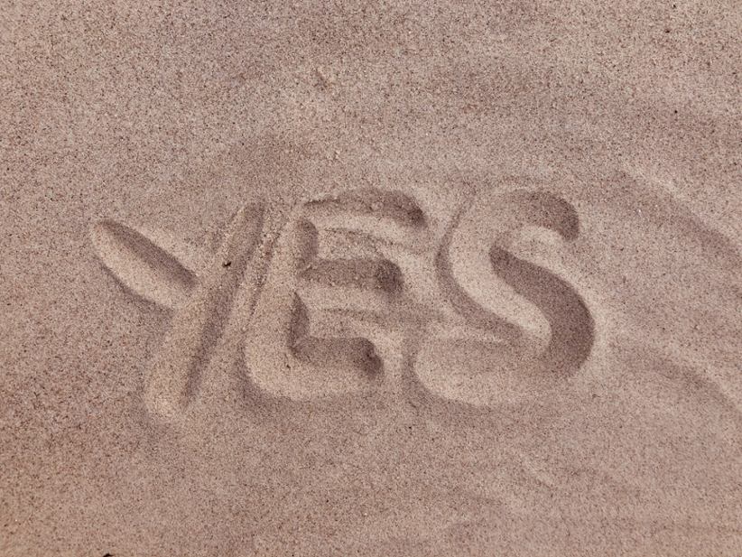 word-yes-written-on-sand
