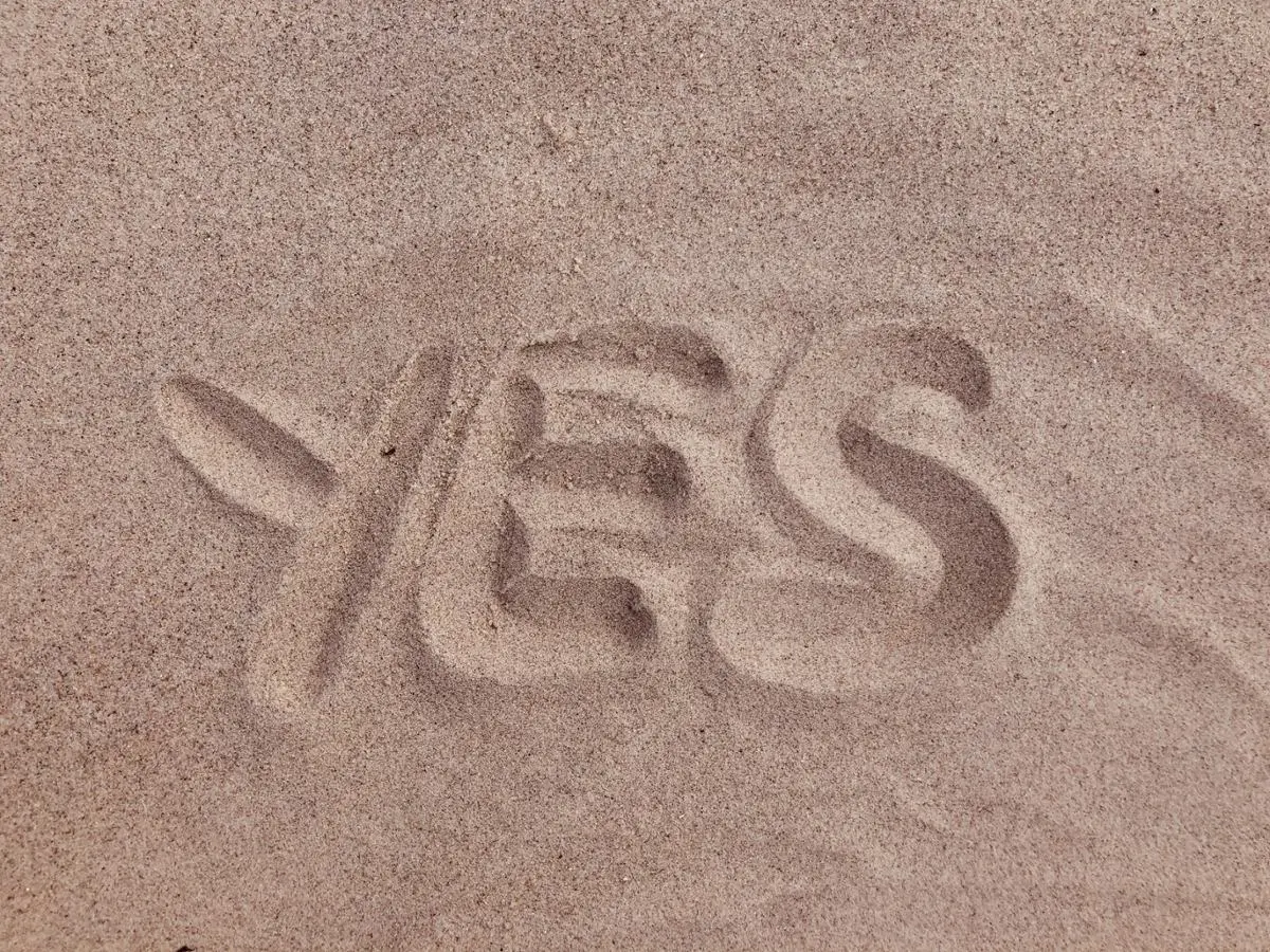 word-yes-written-on-sand