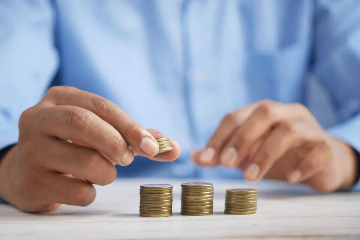 a-person-stacking-coins