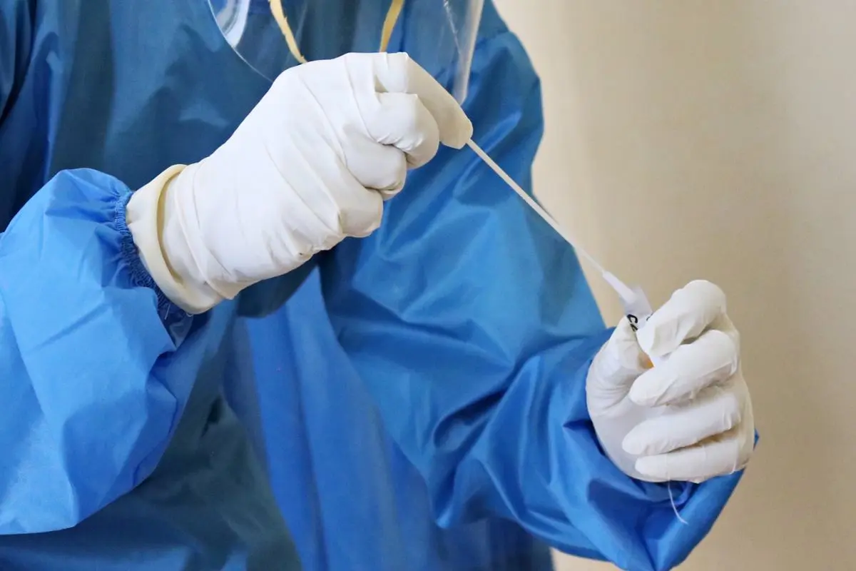 laboratory-worker-in-blue-overalls-taking-swab-test