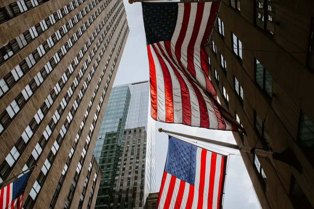 United States, national flag and tall buildings.