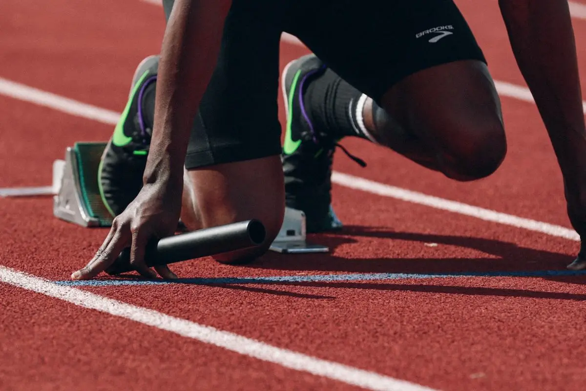 An athlete ready to run in a relay competition.