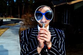 A person looking through a mangnifying glass.