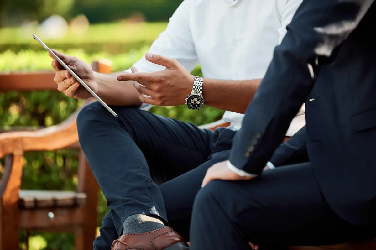 two-businessmen-discussing-a-topic-holding-tablet