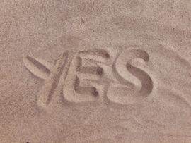 word-yes-written-on-sand