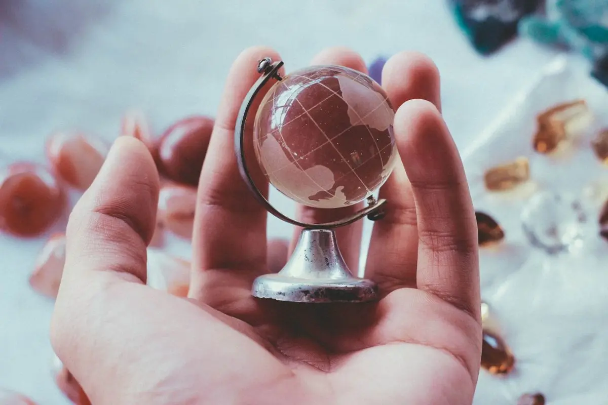 A globe in a person's hands.