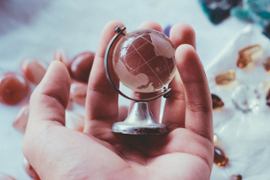 A globe in a person's hands.