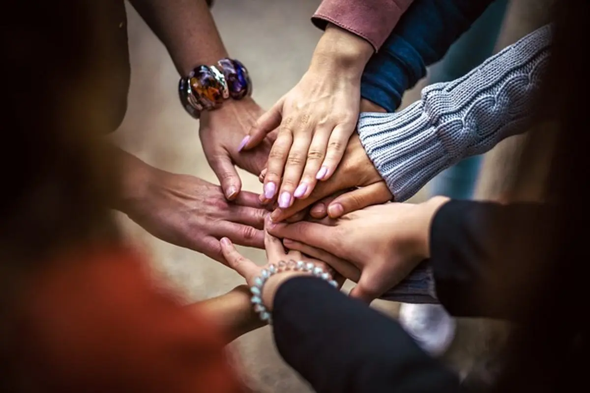 people-making-a-pile-of-hands